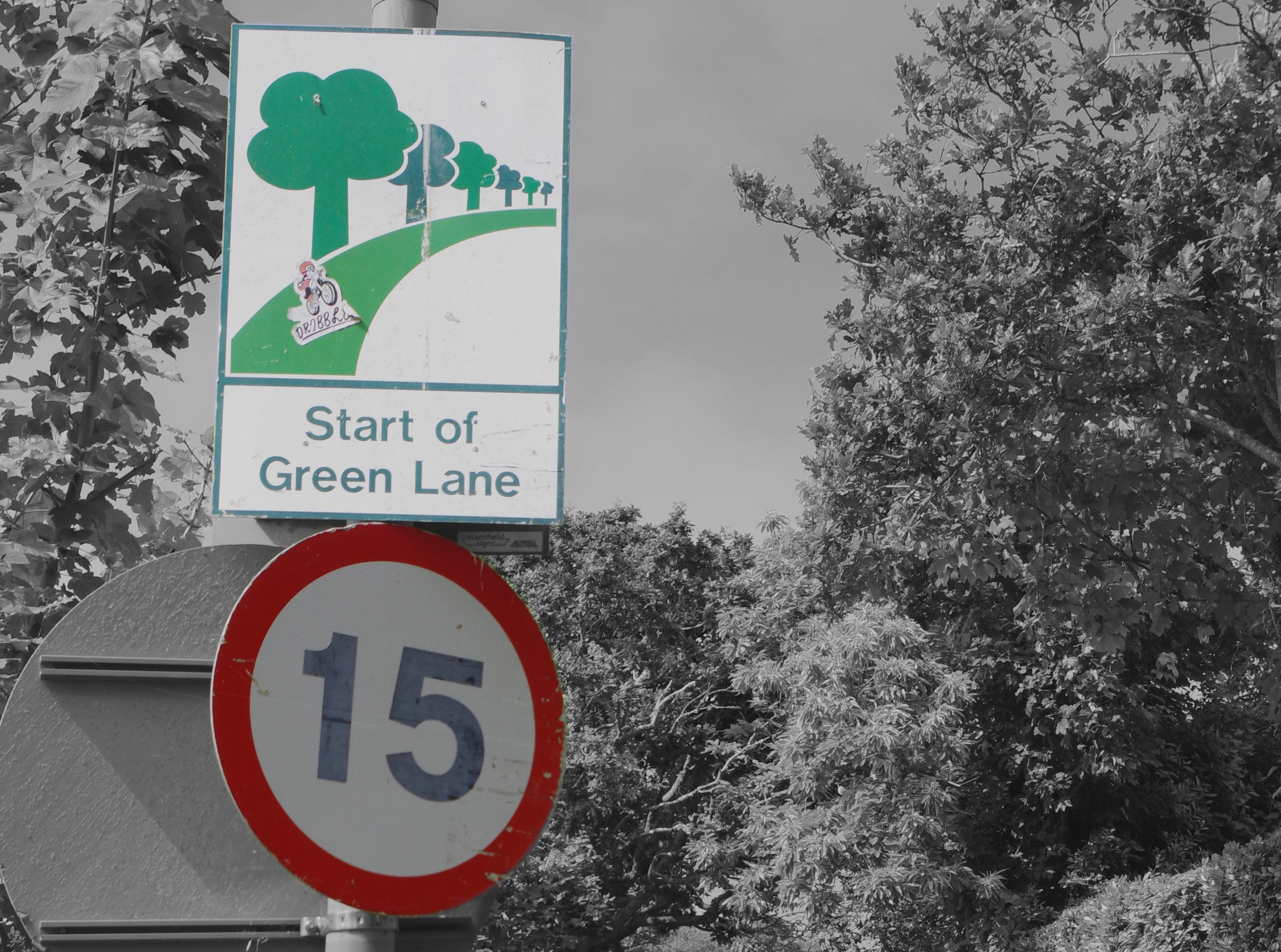 Green Land and 15 mph road signs